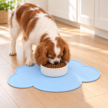 Dog using a blue cloud silicone pet bowl mat in a home feeding scene