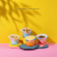 Hocc gradient fish-shaped ceramic cat bowl shown in four color gradients [Gallery: Lifestyle]