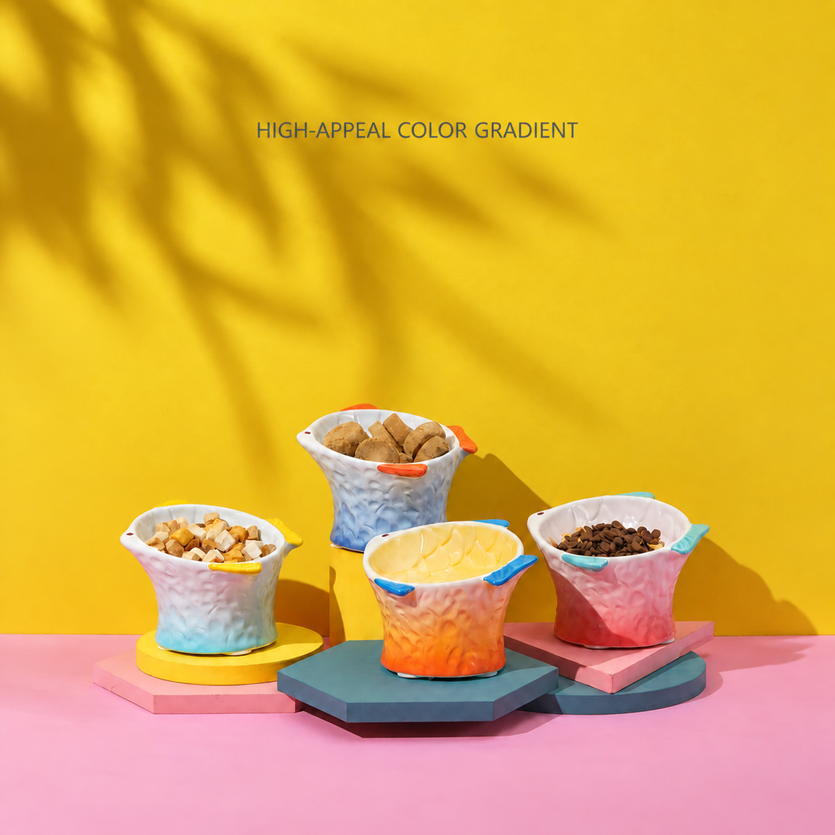 Hocc gradient fish-shaped ceramic cat bowl shown in four color gradients [Gallery: Lifestyle]