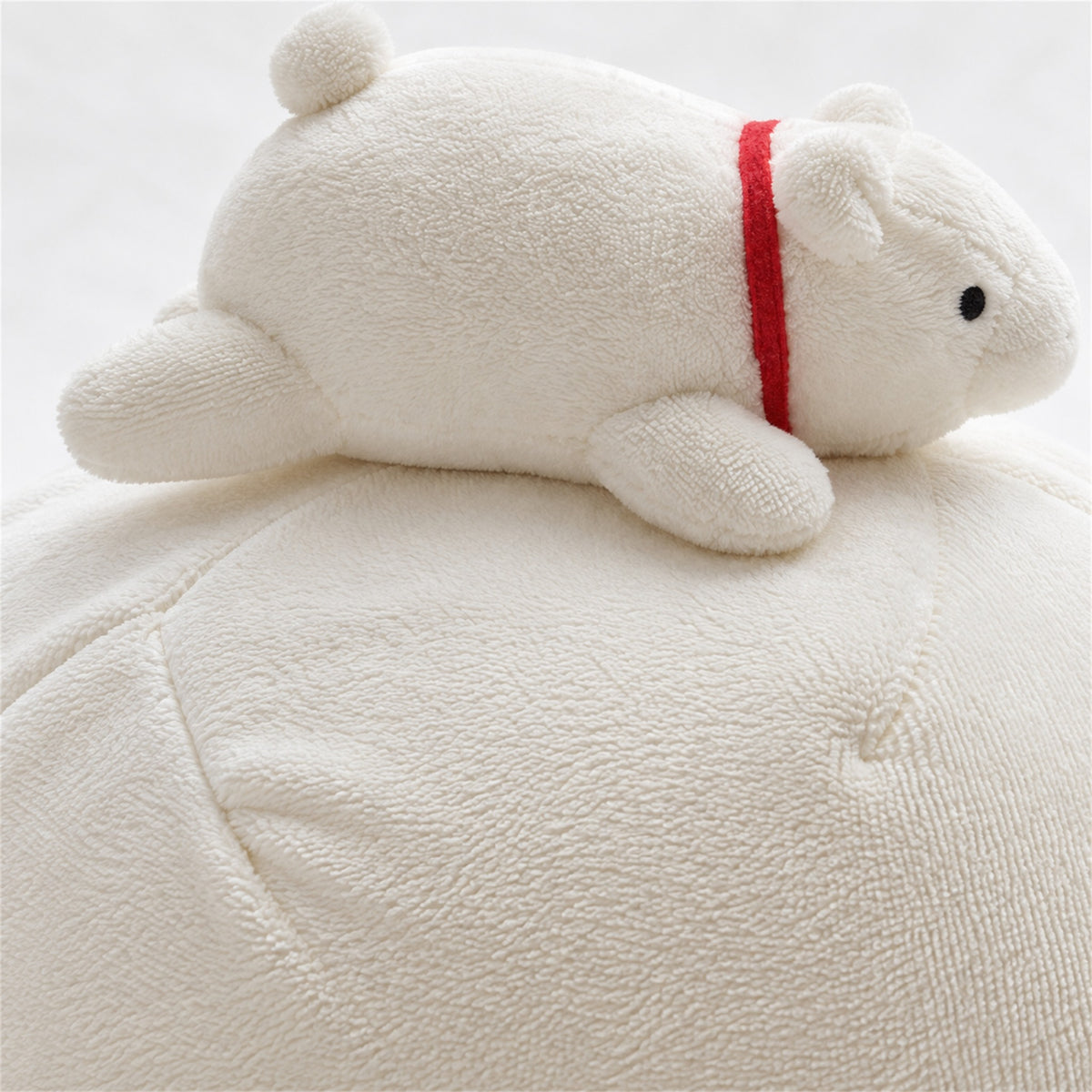 Close-up of white flannel texture and the polar bear companion detail