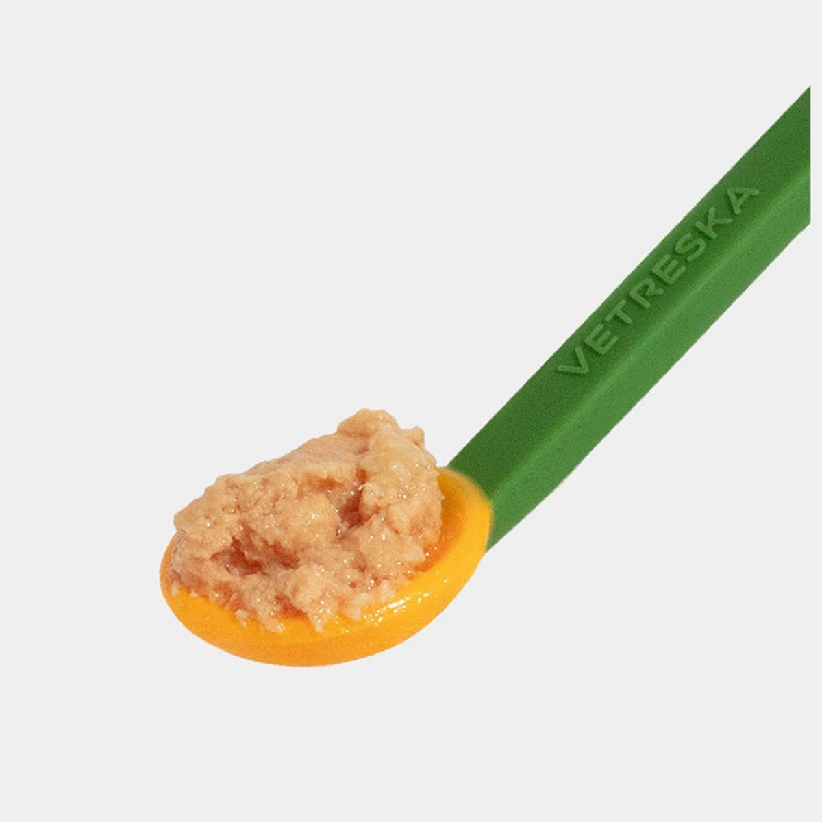 VETRESKA green handled spoon holding wet cat food