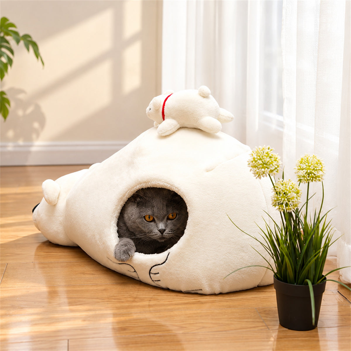 Gray cat resting inside a white polar bear pet cave bed
