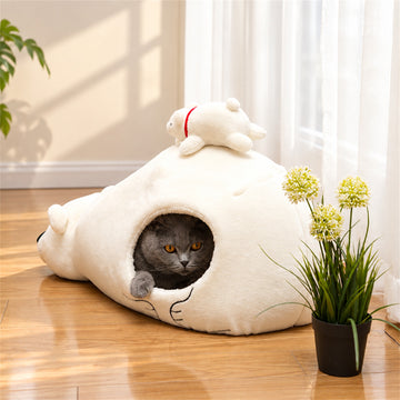 Gray cat resting inside a white polar bear pet cave bed