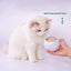 Cat adding freeze-dried treats to the Aiwo rolling cat ball toy
