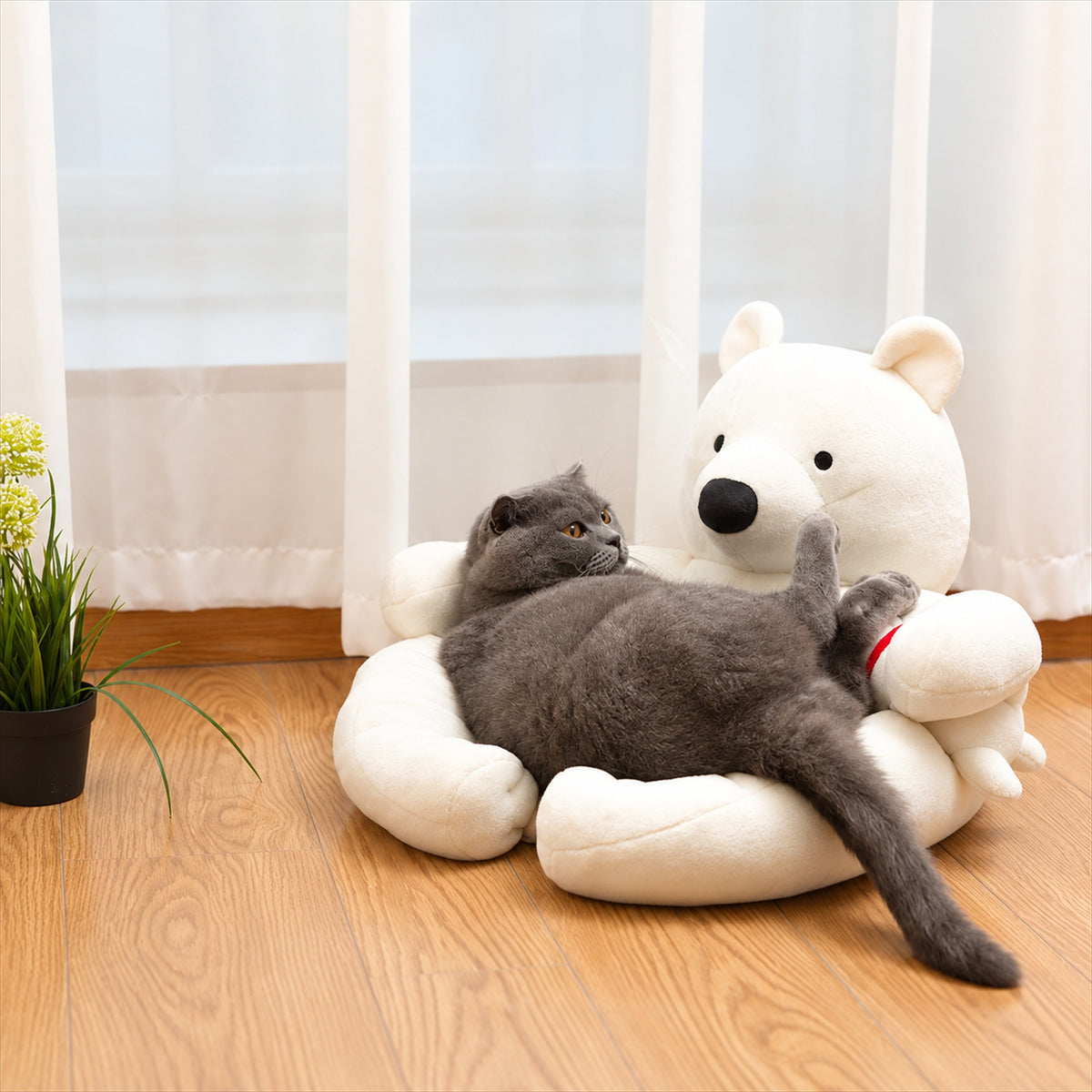Gray cat reclining on a white polar bear pet sofa with bear companion