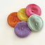 Four colorful felt beret pet hats arranged together