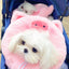 Small dog wearing a pink pig plush pet neck warmer