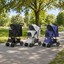 Black, light grey and navy blue jogging pet strollers in a park [Gallery: Shared]