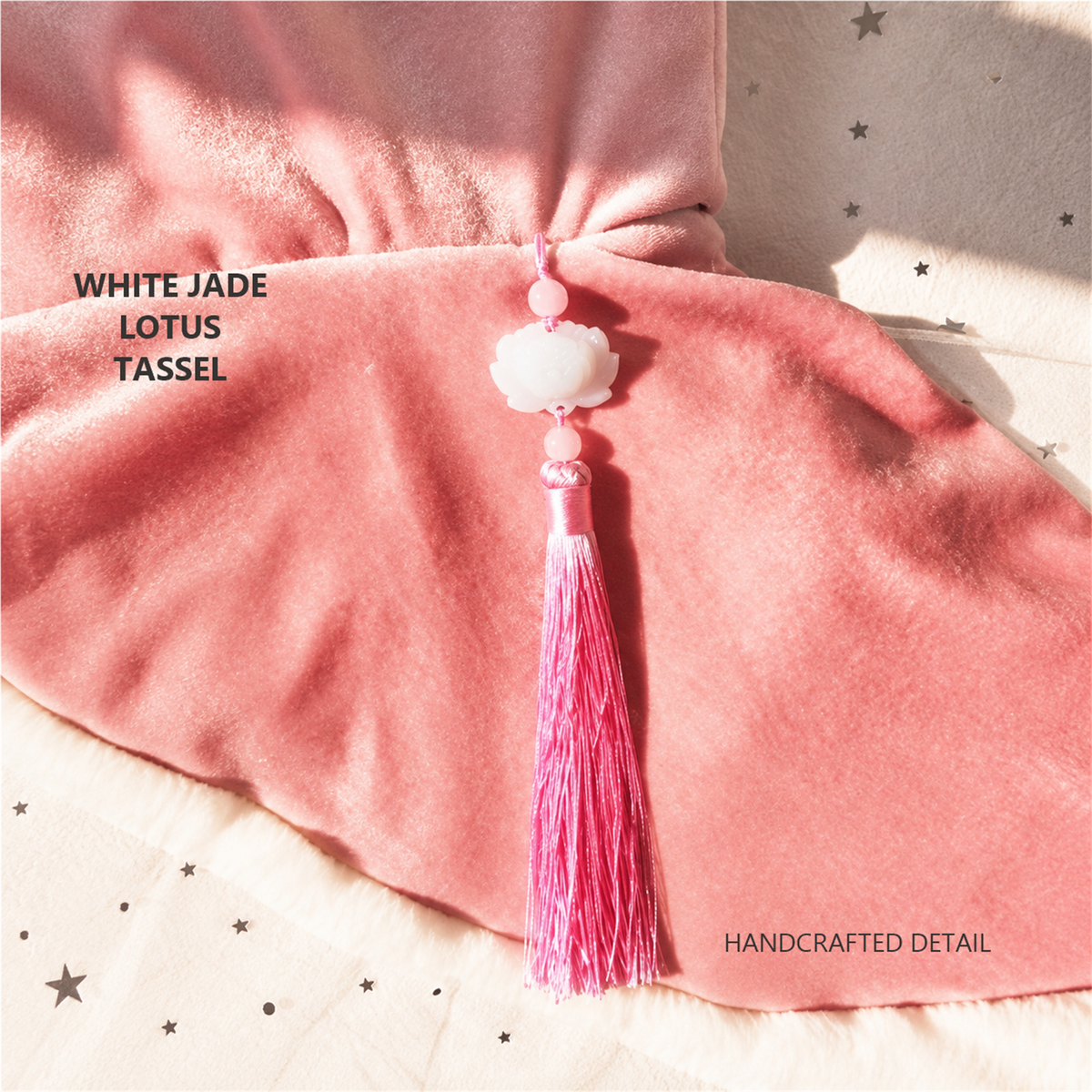 White jade lotus tassel detail on a rose pink cat cape