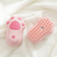 Pink cat-paw brush front and back on a white towel