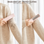 Hand using a portable pet hair remover on a sweater to lift lint