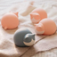 Pink and Blue silicone cat-shaped water bags on a bed