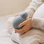 Person holding a Blue silicone cat-shaped hot and cold water bag