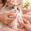 Pakeway LED pet nail clipper used to trim a cat paw at home