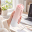 Cat paw temperature-display travel mug held in a bright workspace