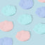 Pastel paw-shaped silicone cat food lids arranged on a blue background