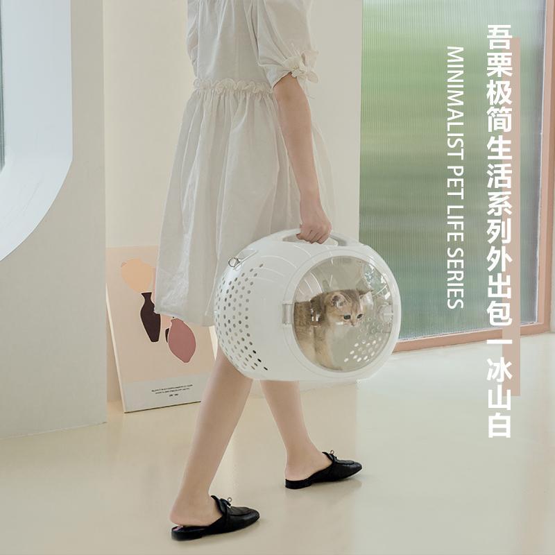 Wulee Space Bag pet carrier lifestyle image with a person carrying the white carrier [Gallery: Lifestyle]