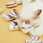 Cat playing with Vetreska Chinese dim sum cat toys on a yellow background